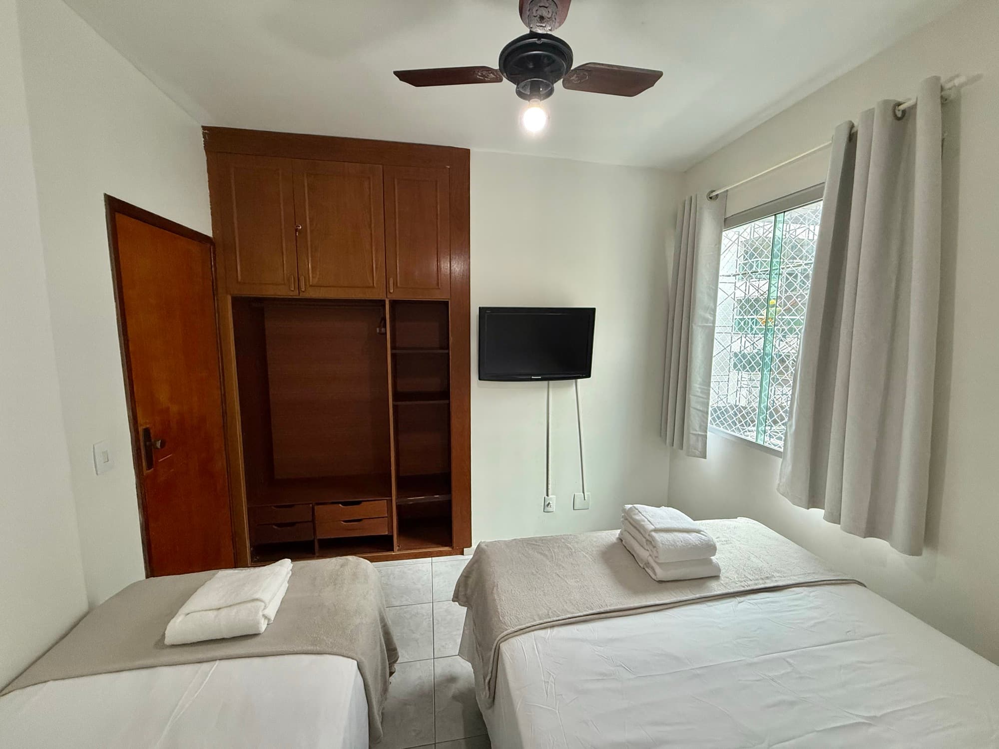 Quarto com camas e guarda-roupa amplo